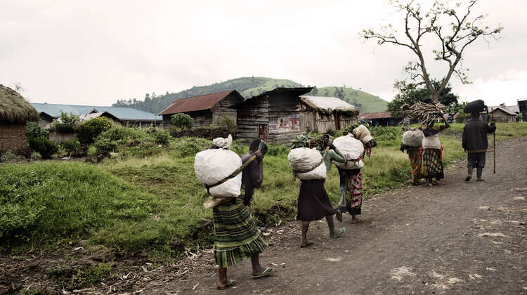 Street scene in North Kivu, DR Congo Women carrying big bags.