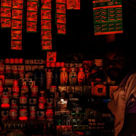 A small trader in front of his store.