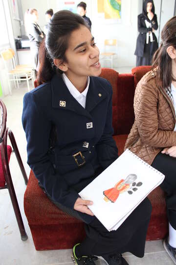 Girl holds picture in school in Domiz, Iraq Payman Fareq holding one of her drawings of a girl. She wants to become an artist.