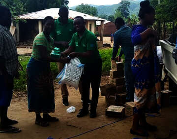 Welthungerhilfe staff members are handing out sacks of maize flour