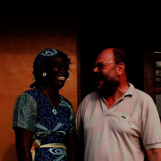 Press trip to Sierra Leone. Antoinette Saffa (Chief Accountant) and Franz Moestl (Project Manager) in front of their office. © World Hunger Aid