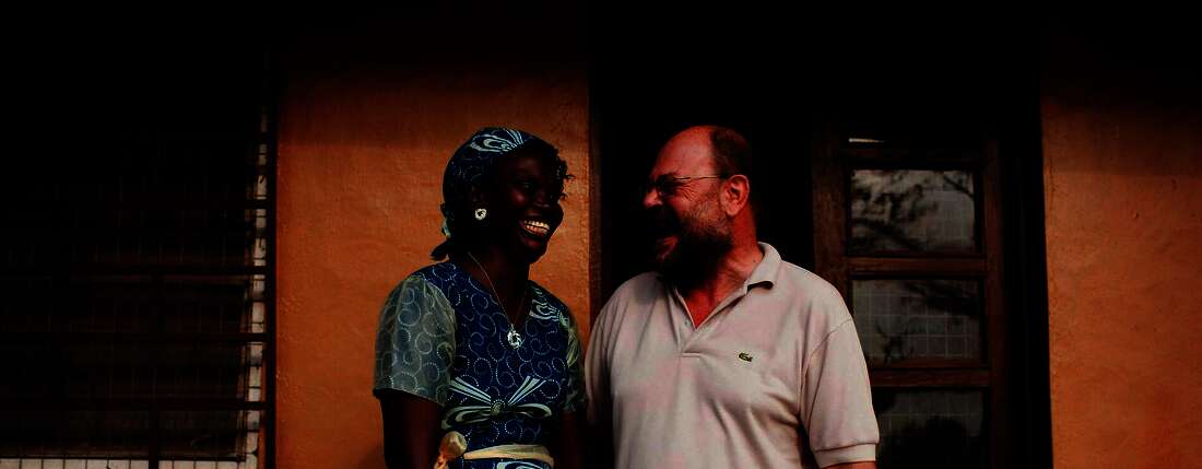 Press trip to Sierra Leone. Antoinette Saffa (Chief Accountant) and Franz Moestl (Project Manager) in front of their office. © World Hunger Aid